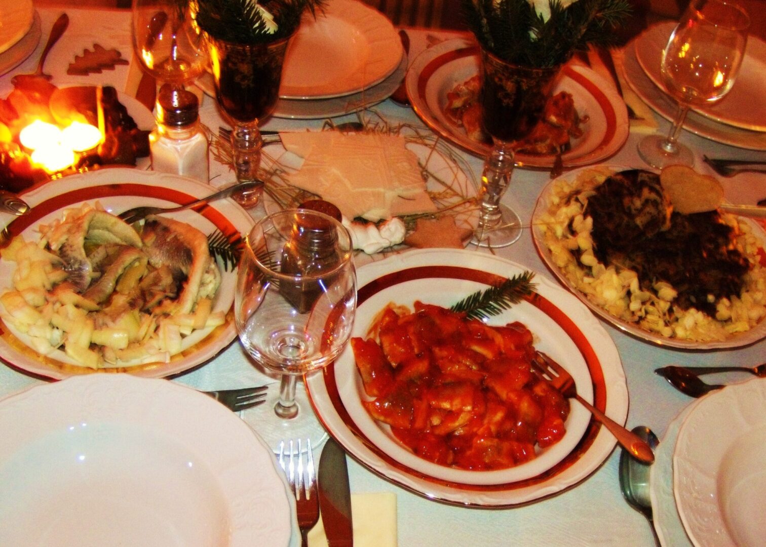 Uroczysty polski stół wigilijny, na którym nie zabrakło tradycyjnych potraw, takich jak śledź w sosie śmietanowym i pierogi. #Wigilia #PolskaWigilia