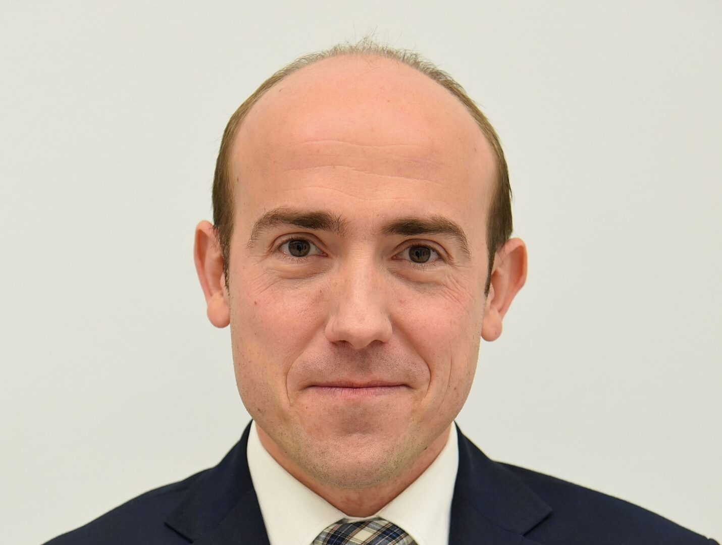 Zdjęcie głowy łysego mężczyzny w garniturze i krawacie