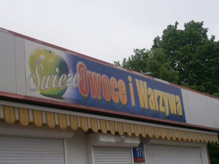 Fresh fruit and vegetable stand with sign reading "Świeże Owoce i Warzywa