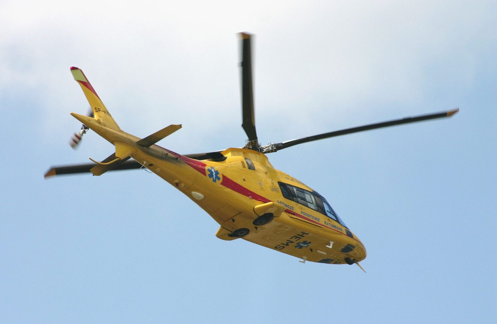 Yellow emergency helicopter in flight. Lotnicze Pogotowie Ratunkowe.