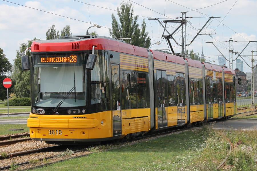 Modern yellow and red PESA 120Na tram, number 3610, on tracks, displaying "Os. Górnicza Zieleniecka 28" destination.