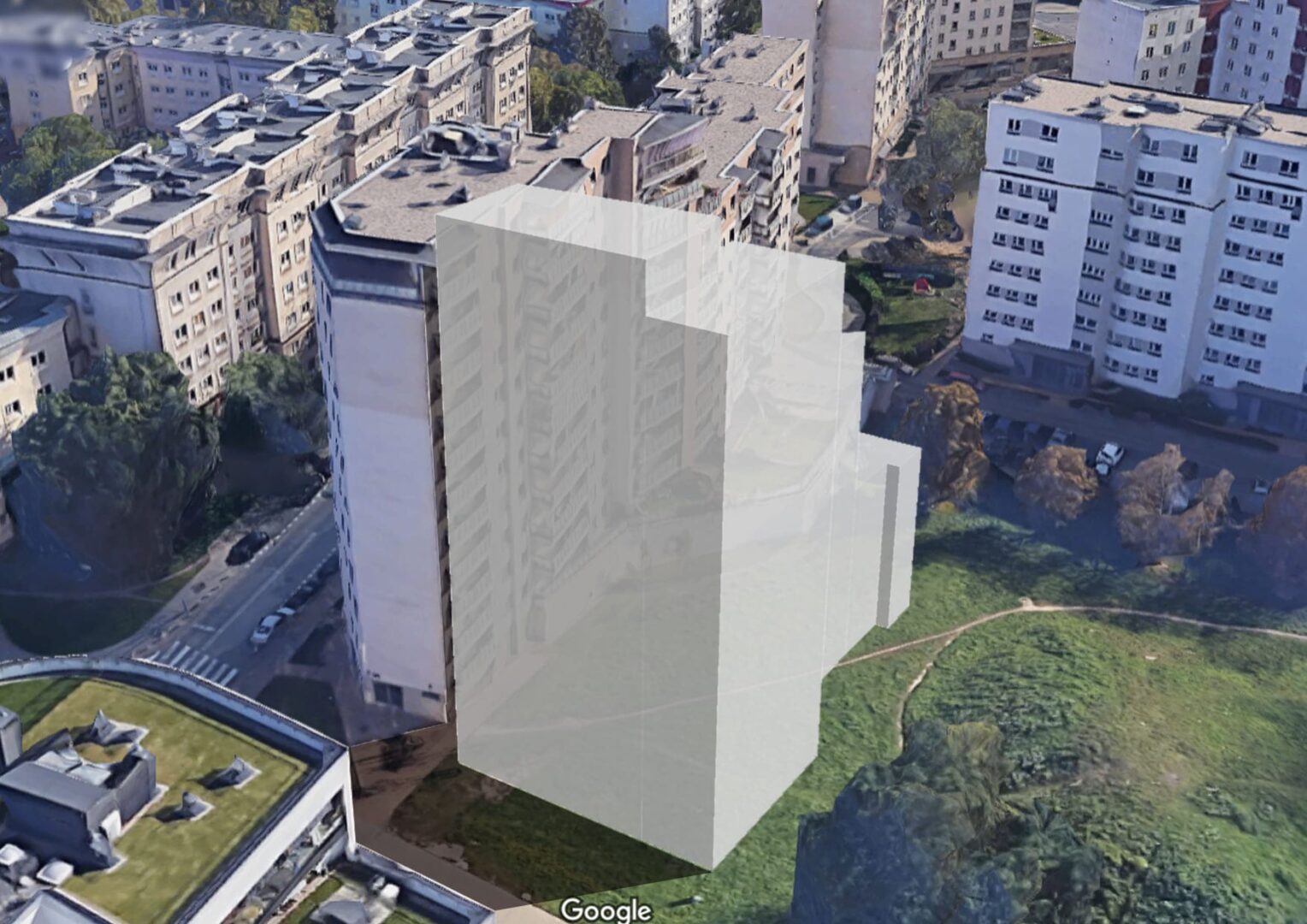 Widok z lotu ptaka na nowy budynek mieszkalny w trakcie budowy, otoczony innymi budynkami mieszkalnymi.