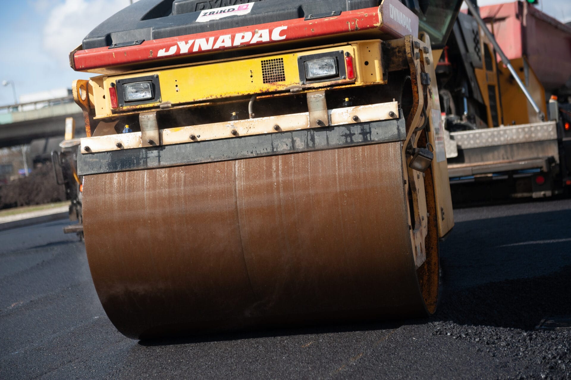 Walec drogowy Dynapac zagęszczający asfalt podczas budowy drogi.