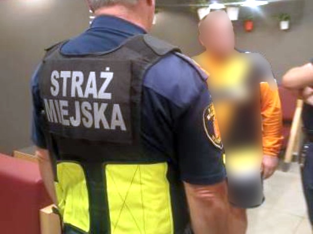 Funkcjonariusz Straży Miejskiej z zatrzymaną osobą.