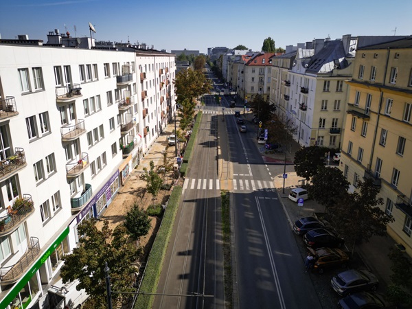 Widok z lotu ptaka na ulicę miasta z nowoczesnymi budynkami mieszkalnymi i zaparkowanymi samochodami.