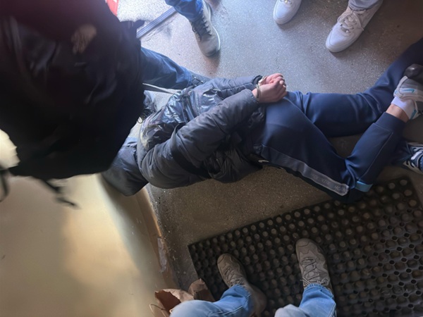 Skuty podejrzany leży na podłodze w czasie aresztowania.