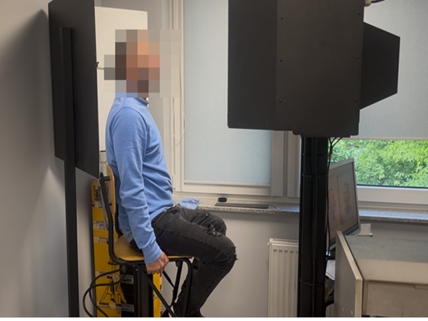 Mężczyzna siedzący naprzeciwko policyjnego urządzenia identyfikacyjnego. Śledztwo w sprawie oszustwa.