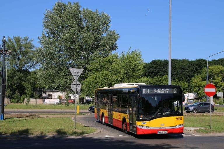 Żółto-czarny autobus miejski numer 103 na ulicy miejskiej.